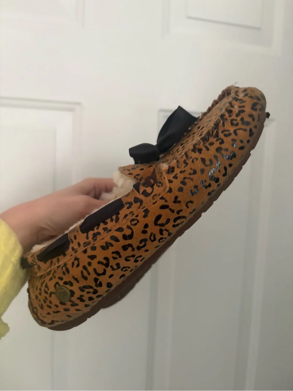 UGG women’s Leopard Print Faux-Fur Lined Slip-Ons in Brown and Black